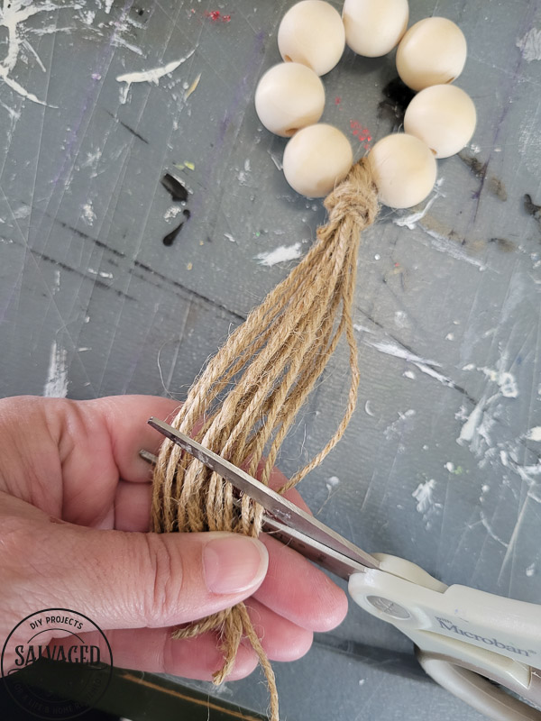 How to make DIY wood bead napkin holders for farmhouse style table settings and budget entertaining. #tablescape #woodbeadidea #vintagestyle #neutraldecor