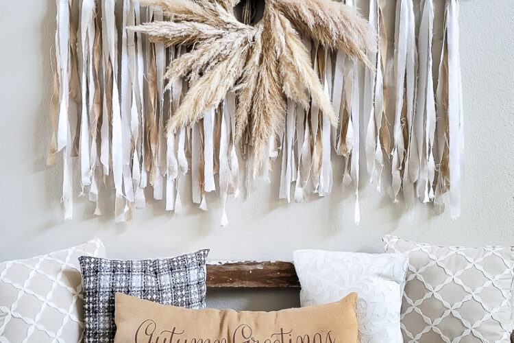 Learn how to make the large scale wall hanging I use in my living room. This shabby chic wall art is perfect fora large space or make it small and DIY this idea to fit your needs. Using an old sheet, burlap and drop cloth you can create a boho wall hanging in no time. #dropclothcraft #walldecor #wallartideas #DIYbohodecor