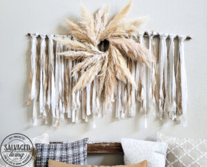 Learn how to make the large scale wall hanging I use in my living room. This shabby chic wall art is perfect fora large space or make it small and DIY this idea to fit your needs. Using an old sheet, burlap and drop cloth you can create a boho wall hanging in no time. #dropclothcraft #walldecor #wallartideas #DIYbohodecor