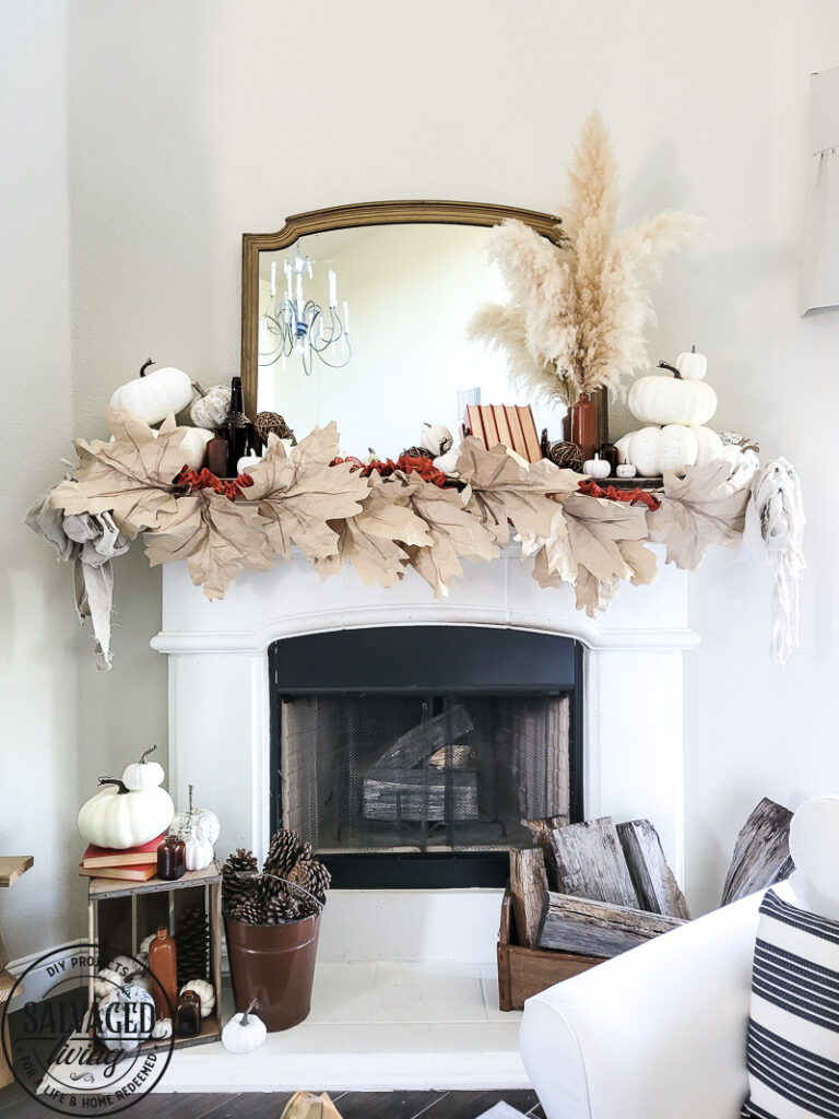 Learn how to make DIY giant paper leaf garland for your fall mantel or fall decorating. This budget garland idea is perfect to add a warm touch of fall to your home and the tutorial is so easy! Mix in some white pumpkin decor, gathered ribbon garland and cozy books for a cozy fall decor idea! #fallvibe #papergarland #papercraft 