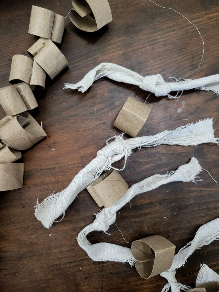 Instead of throwing away your old toilet paper and paper towel rolls, we can turn them into a beautiful farmhouse garland you will use for years to come! #farmhouse #papertoweltube #garland
