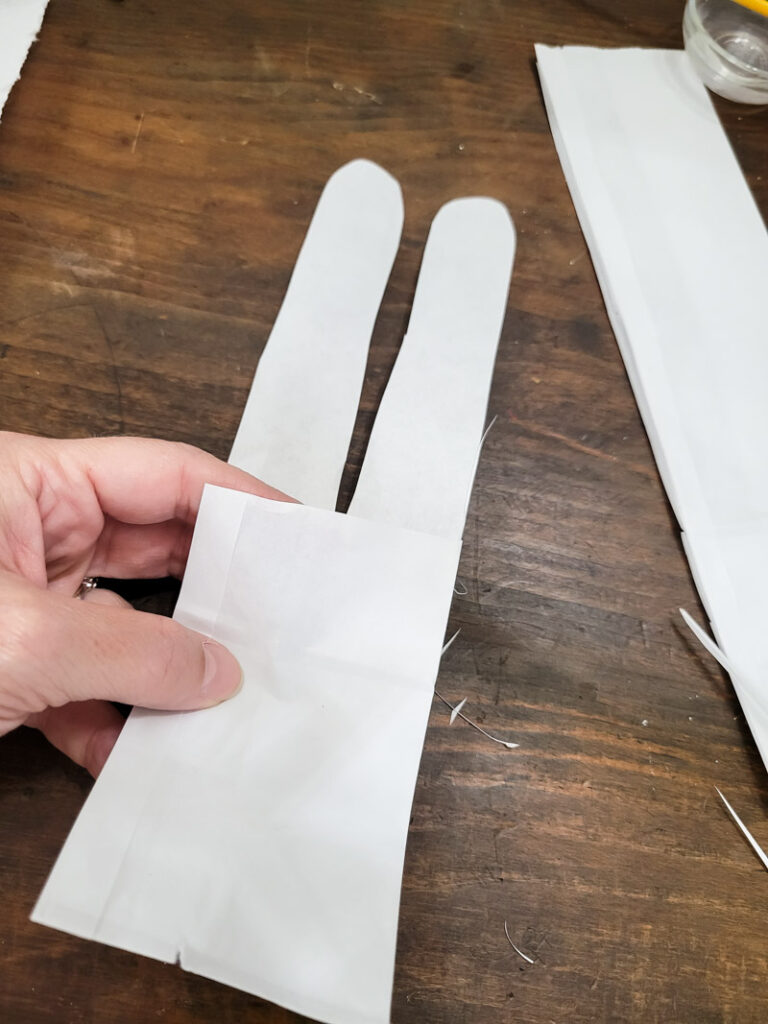 Use a lunch sack to create the cutest DIY utensil holders for Easter! This is the perfect craft to do with your kids, and use them all season before trashing them-- guilt free! #kidcraft #easterdiy #easyeastercraft