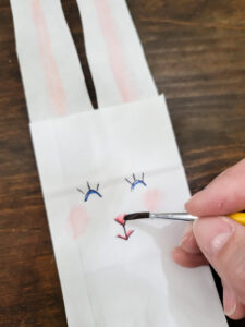 Use a lunch sack to create the cutest DIY utensil holders for Easter! This is the perfect craft to do with your kids, and use them all season before trashing them-- guilt free! #kidcraft #easterdiy #easyeastercraft