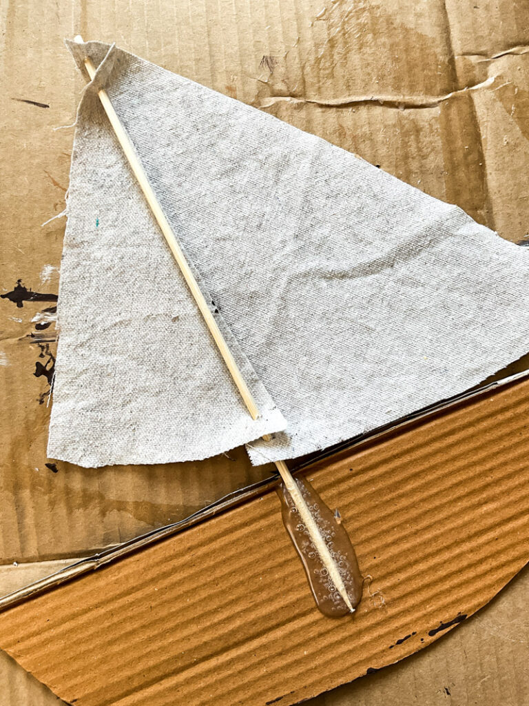 It's easy to make a DIY sailboat from cardboard, I'll show you how! Perfect for all of your summer decorating for years to come! #cardboard #sailboat #summerdecor 