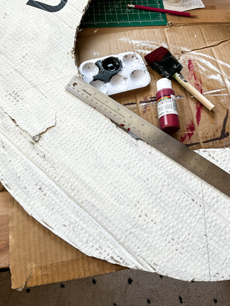 Make a life-size life preserver for vintage summer decorating. This large cardboard project will add a vintage vibe to your beach house, summer vignette or nautical decor motif. So easy and super budget-friendly. #budgetsummerdecor #beachtheme #vintagestylesummer