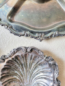 how to hang silver platters like a pro for the most stunning silver gallery wall full of vintage silver serving pieces! A silver collectors dream, there are so many ways to decorate with vintage silver pieces. #silvercollection #gallerywall #vintagesilver