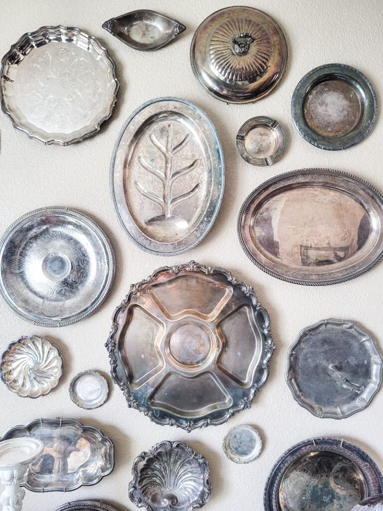 how to hang silver platters like a pro for the most stunning silver gallery wall full of vintage silver serving pieces! A silver collectors dream, there are so many ways to decorate with vintage silver pieces. #silvercollection #gallerywall #vintagesilver 