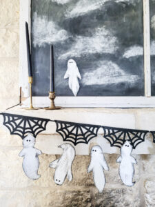 Cheap Halloween decor idea! Grab this free pattern! Free ghost pattern for DIY cardboard ghosts, perfect for your Halloween mantle or Halloween tablescape. Make sweet Halloween ghosts or scary Halloween ghouls with this budget friendly Halloween craft! #cardboardcraft #cheapHalloween #Halloweengarland #freeHalloweendecor