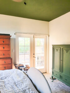 Master bedroom redo. Vintage paint color palette and budget curtain hack, get the look for less from Ballard Design. Buffalo check curtains make big impact for cheap. #greenbedroom #vintagebedroom #taxidermy #affordablecurtains