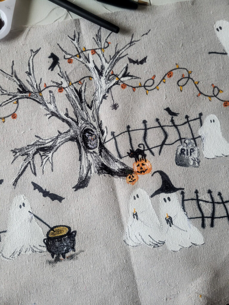 This scary squad halloween table runner would normally cost you $99... but I'm going to show you how to make it for $15 or less! Such a budget-friendly, fun project for Halloween. #halloweenDIY #halloweenproject #tablerunnerDIY #spookyDIY #budgetfriendlyhalloweendecor #cheaphalloweendecor #halloweendecordupe
