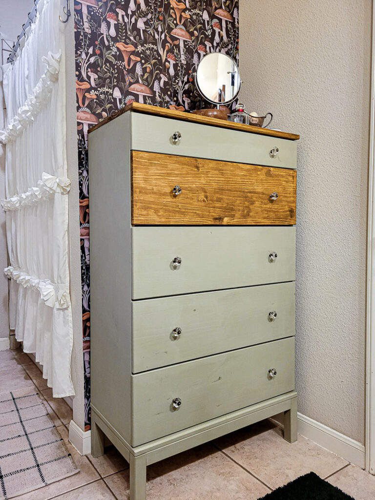 budget bathroom storage ikea tarver dresser makeover hack. Perfect for small space storage and a budget bathroom update, this dresser lets you paint and style to your vibe! Perfect for this vintage bathroom update. #ikeahack #budgetstorage 